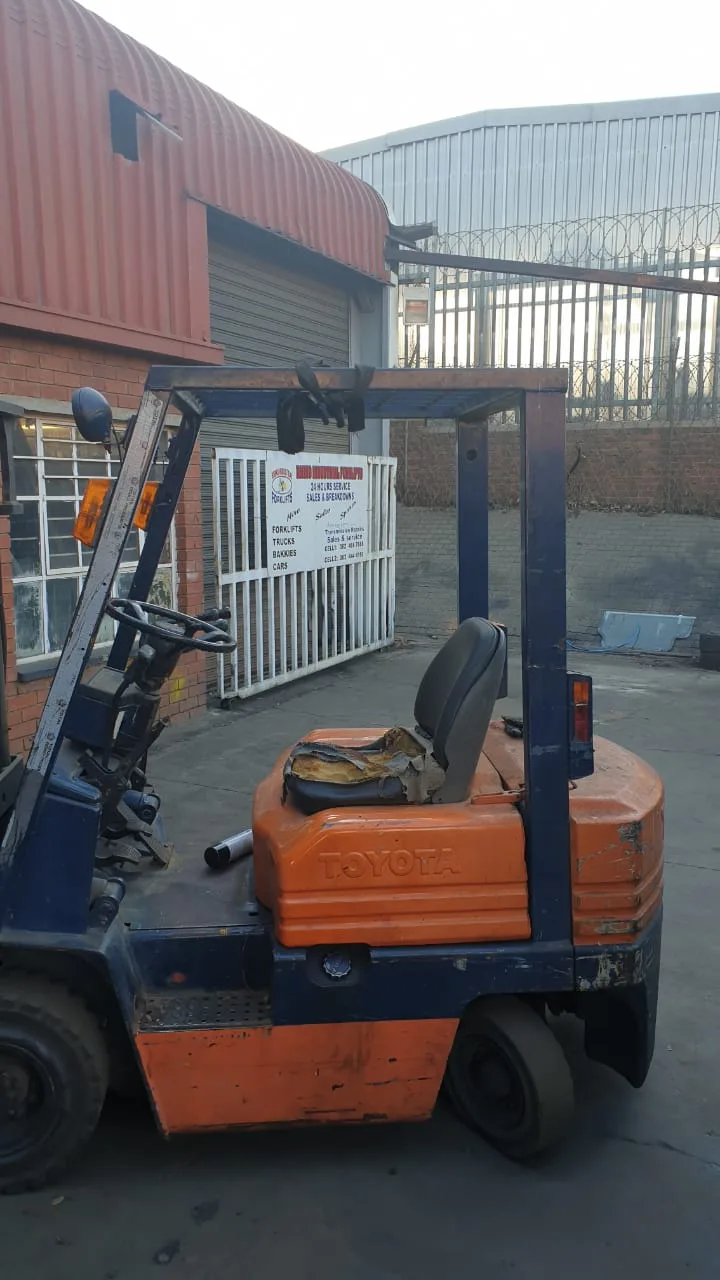 Orange forklift parked outside Rhino Industrial Forklifts workshop